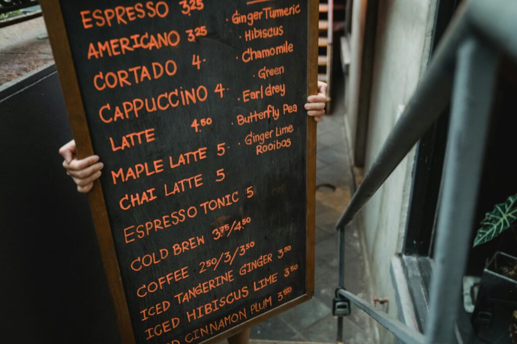 worker-carrying-blackboard-with-cafe-menu