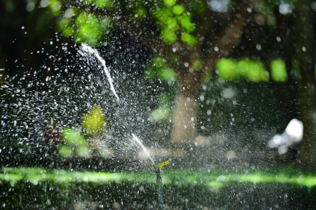 garden-sprinkler-watering-lush-green-lawn