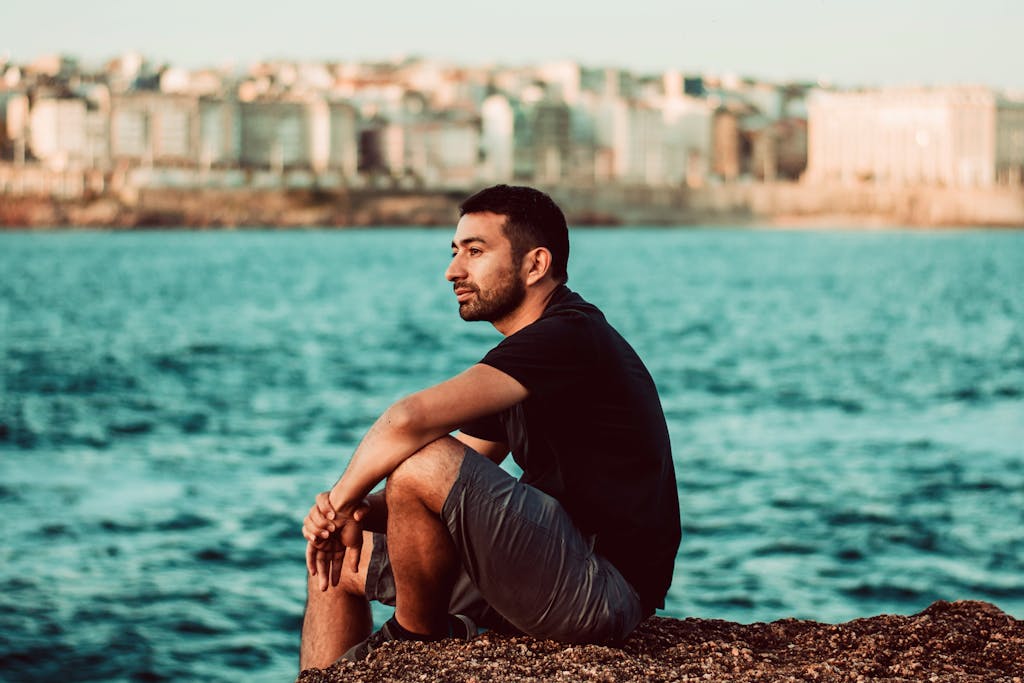 Portrait of a thoughtful man sitting by the seaside in A Coruña, Spain.