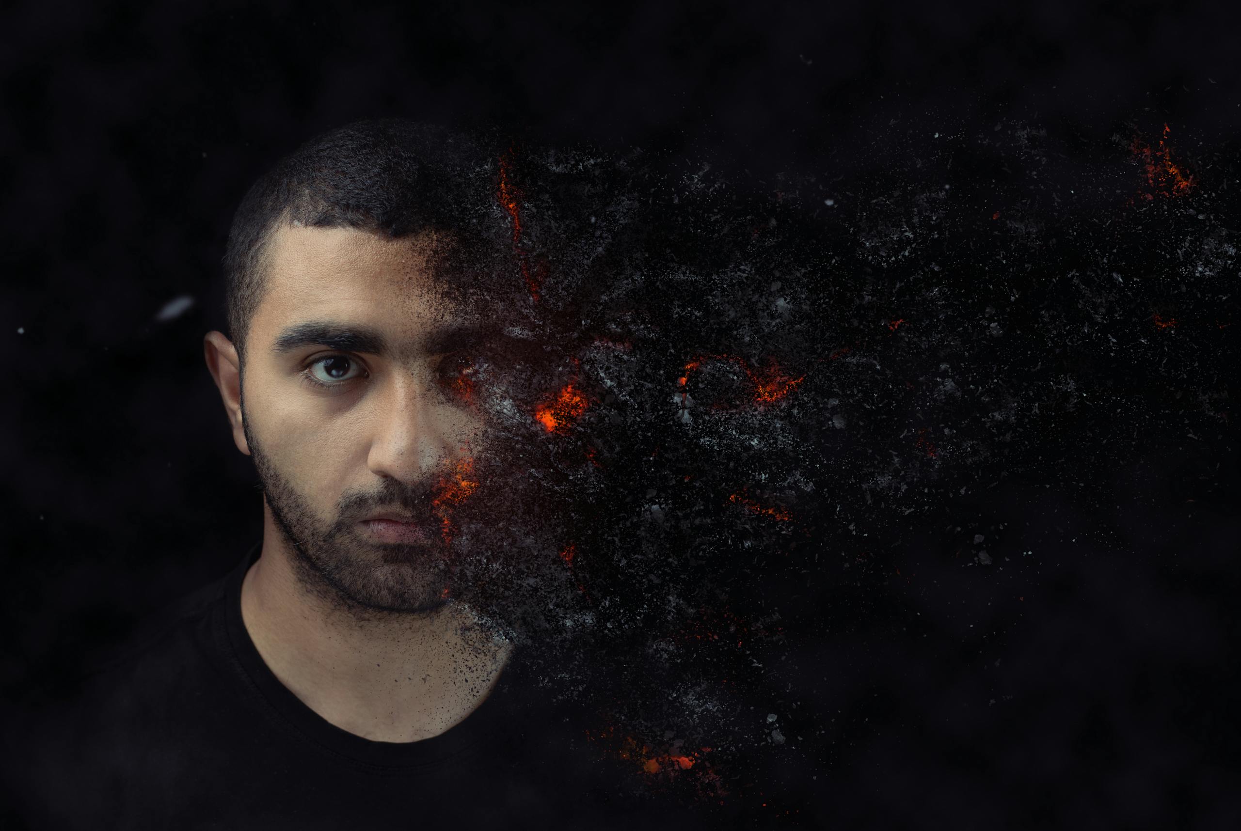 Portrait of a young man with a surreal distortion effect blending with a dark, cosmic background, creating a dramatic visual