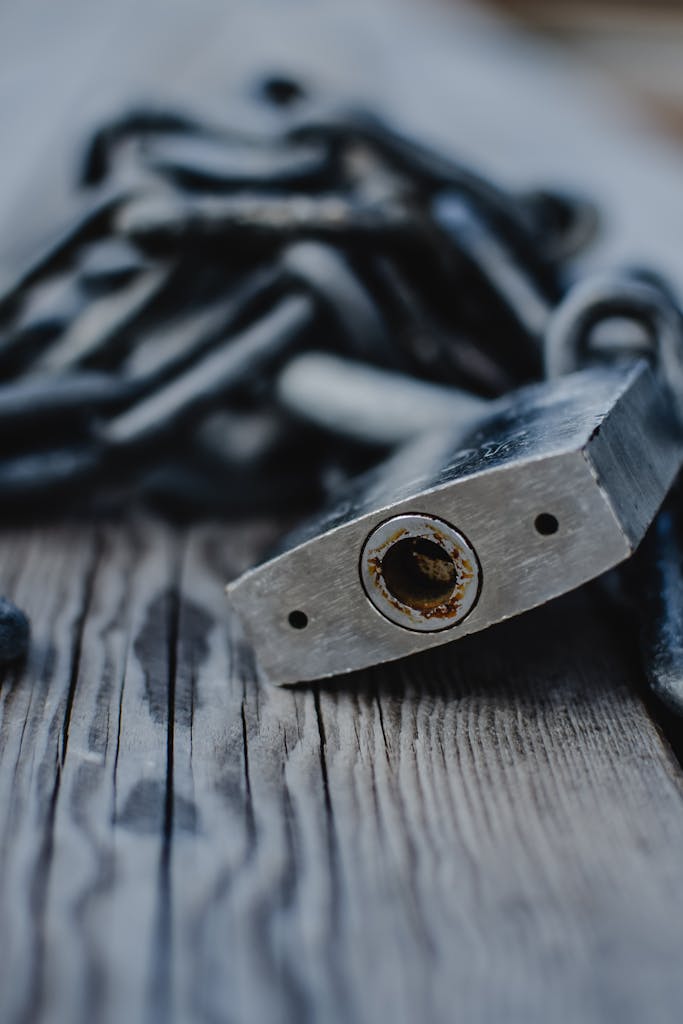 Rusty padlock on wooden deck, symbolizing security and wear over time.
