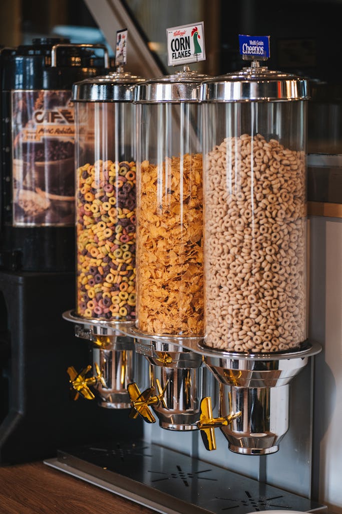 Three cereal dispensers filled with different cereals in a cafe setting. Perfect for breakfast imagery.