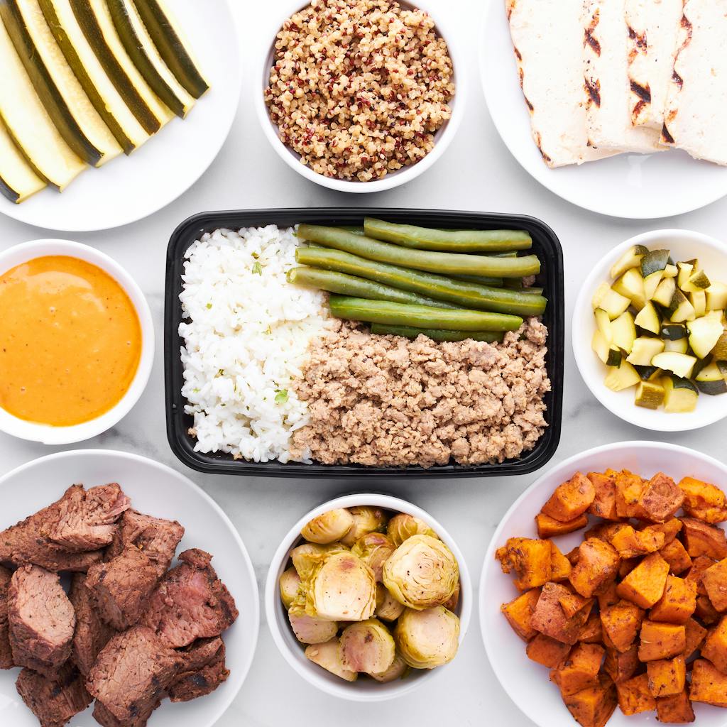 Top view of healthy meal prep with various vegetables, grains, and proteins for a balanced diet.
