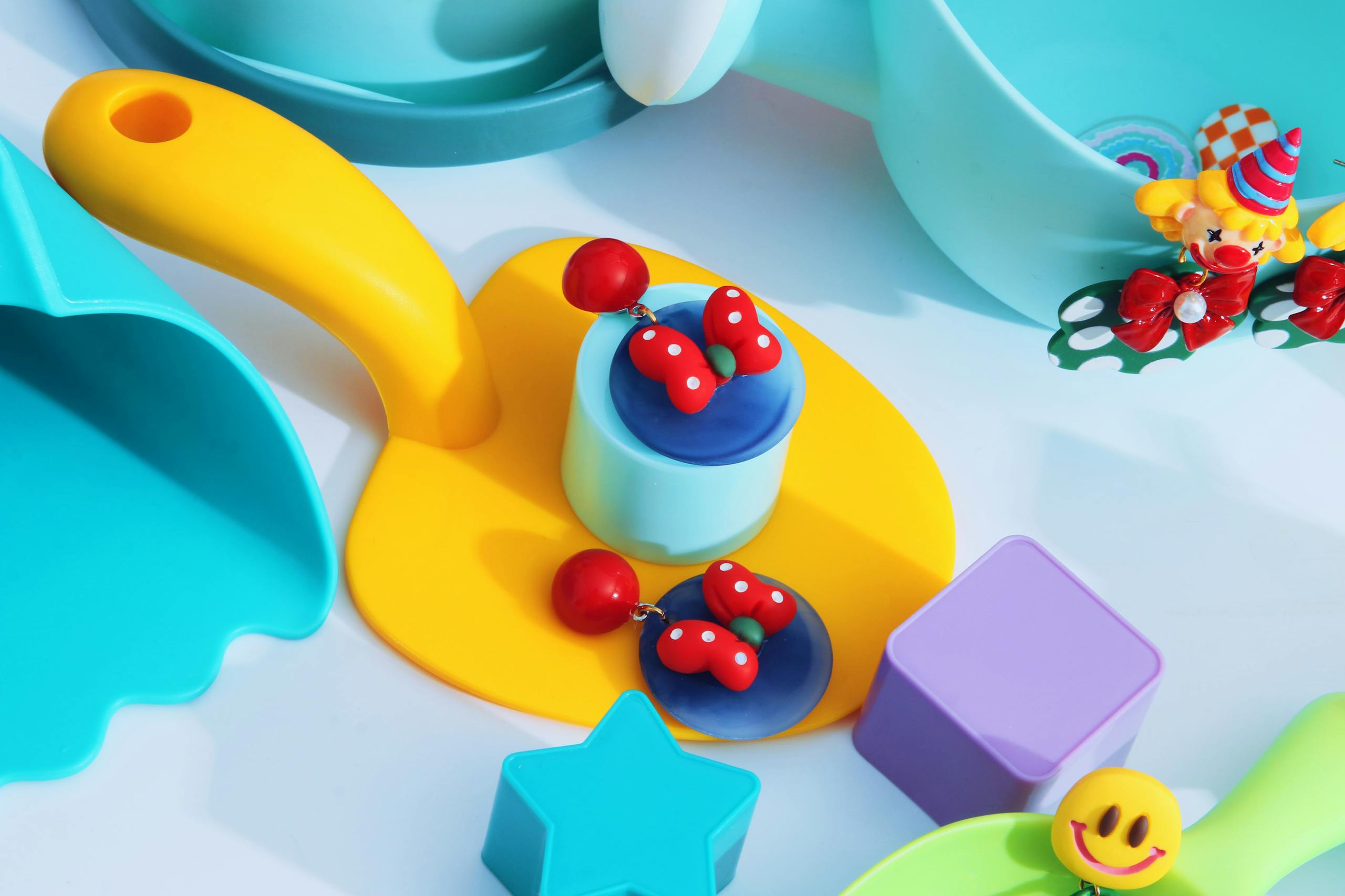 Vibrant collection of colorful plastic toys and geometric shapes in a playful composition.