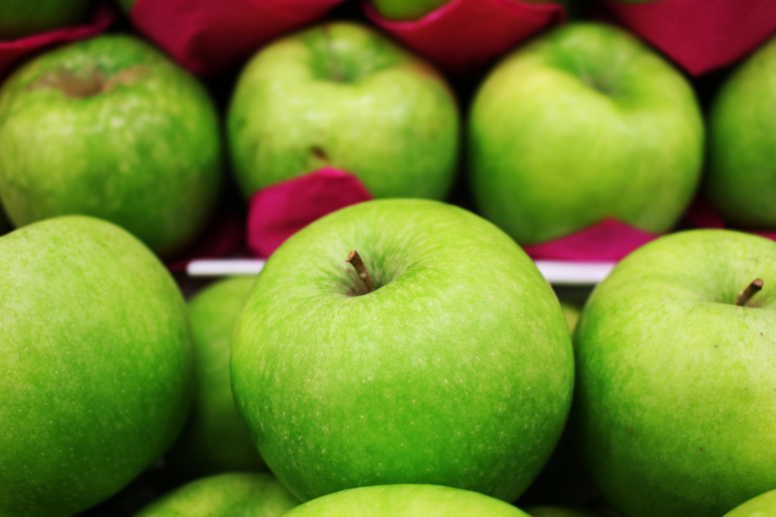 Vibrant green apples in a close-up shot with a vivid and fresh appeal.