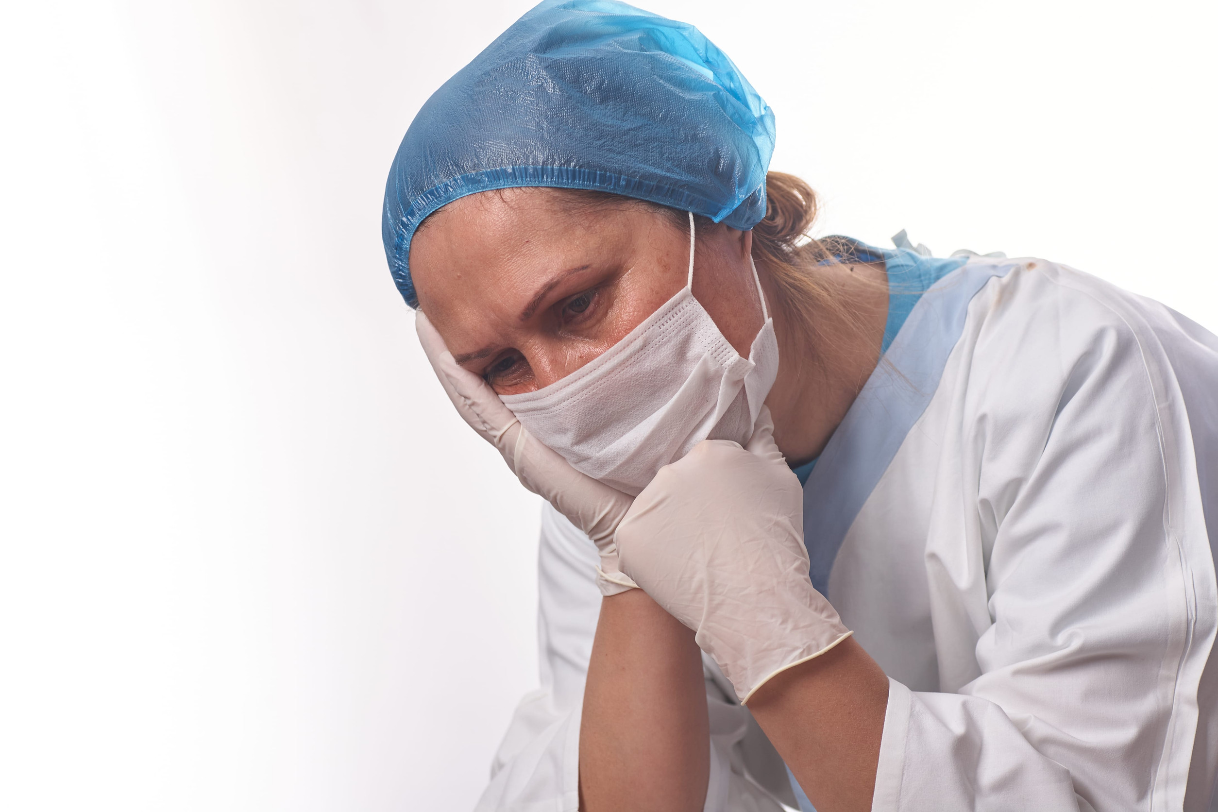 Portrait of a female doctor surgeon feeling down, exhausted, frustrated, very tired, .... on white background