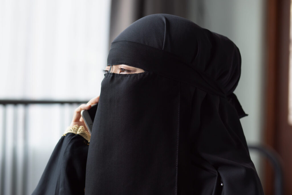 Middle Eastern, Saudi Arabian muslim woman talking via her smartphone