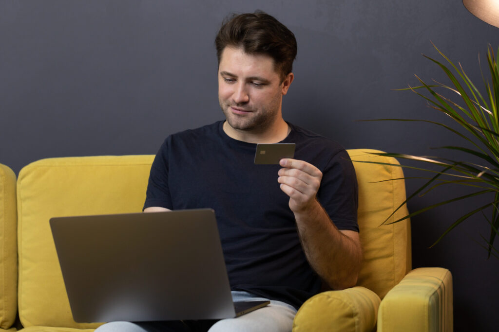 guy makes purchases or payments online, looks at credit card cvv security code