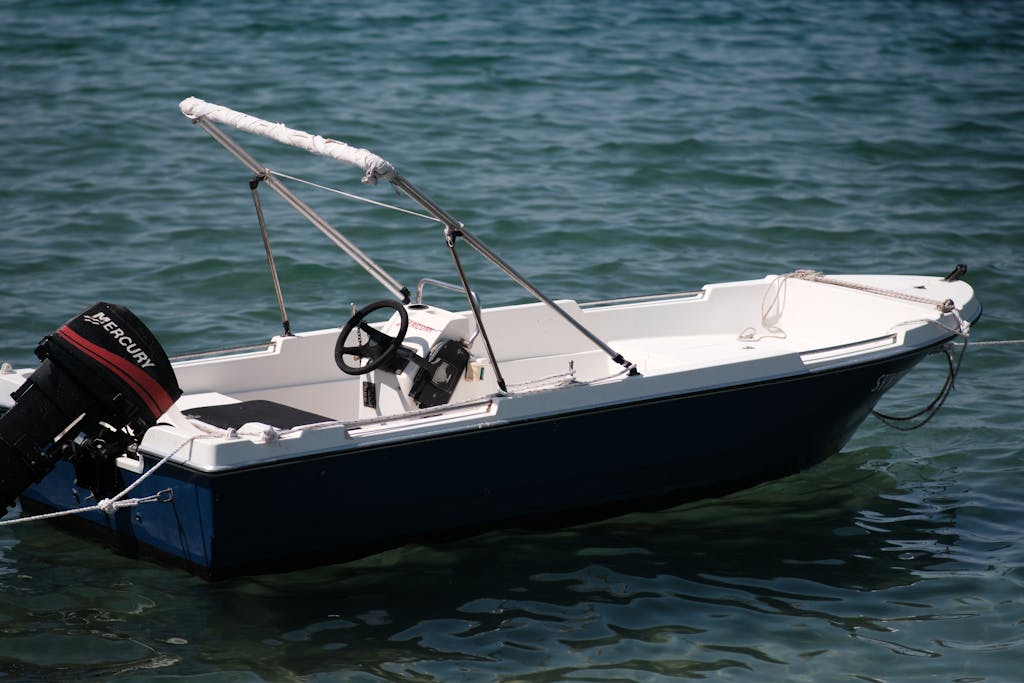 A fishing boat anchored in clear blue waters, capturing a sunny day in Foça, İzmir.