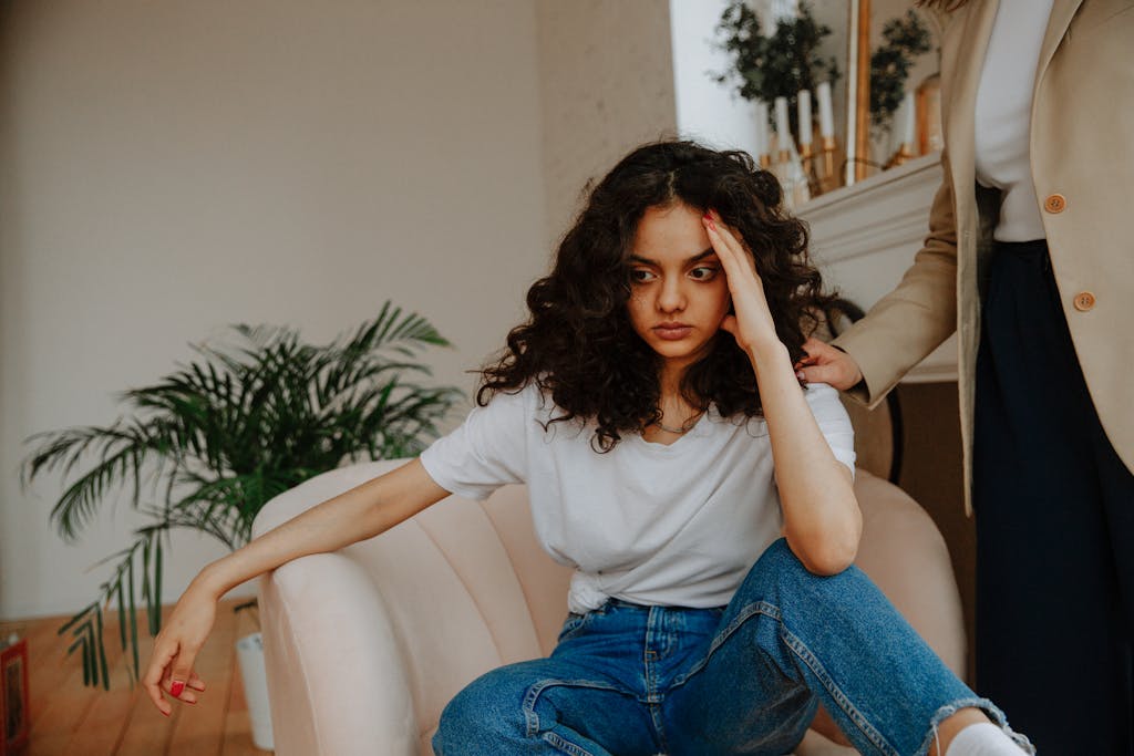 A young woman experiencing a moment of reflection during a therapy session indoors.