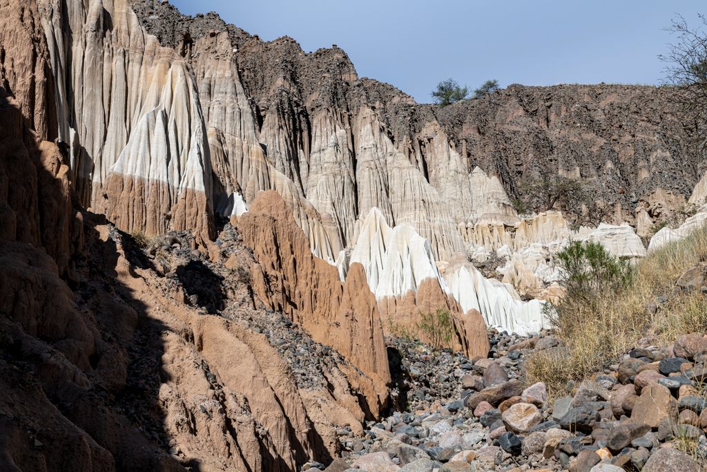 Captivating view of volcanic rock formations with striking colors in a barren desert landscape, perfect for nature enthusiasts.