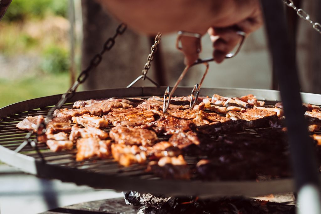 Close-up of beef steaks sizzling on a grill. Perfect for outdoor cooking enthusiasts.