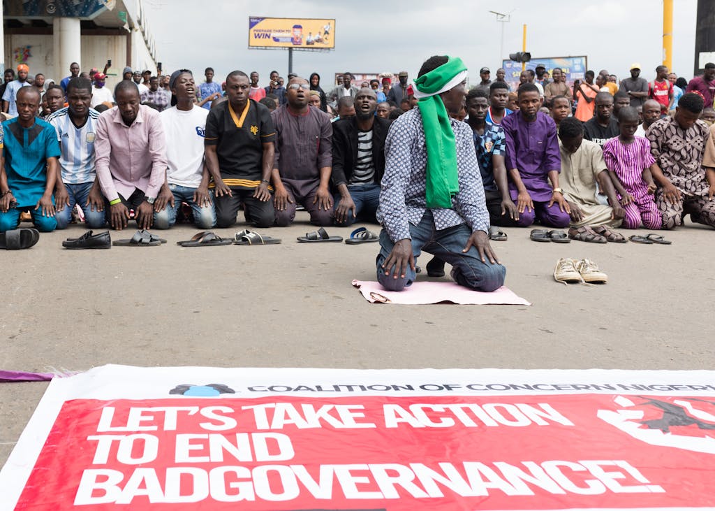 Group peacefully protesting in Nigeria with a banner demanding action against bad governance.