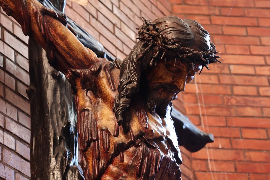 Intricate detail of a crucifix in El Puerto de Santa María, capturing religious devotion.