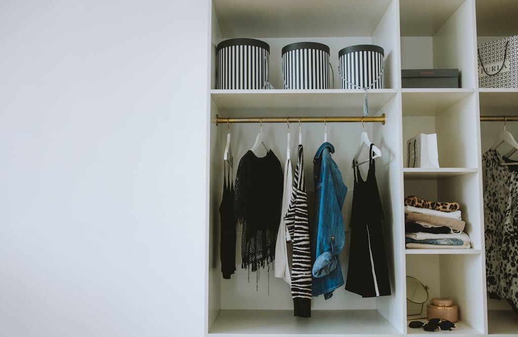 Organized wardrobe with trendy clothes, hangers, and storage boxes.