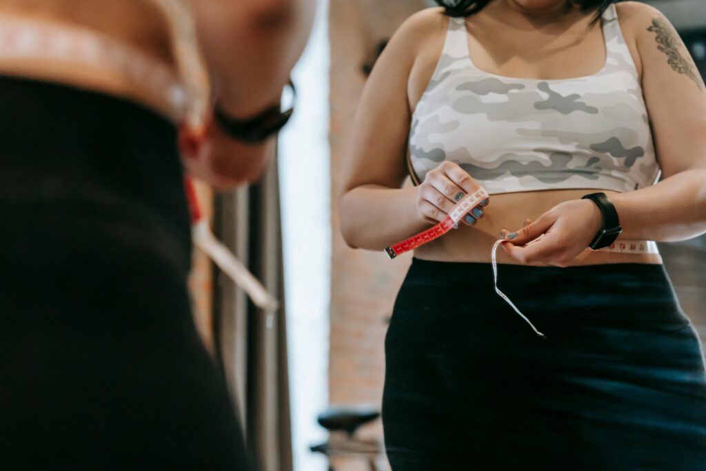 measuring-waist-with-tape-in-gym