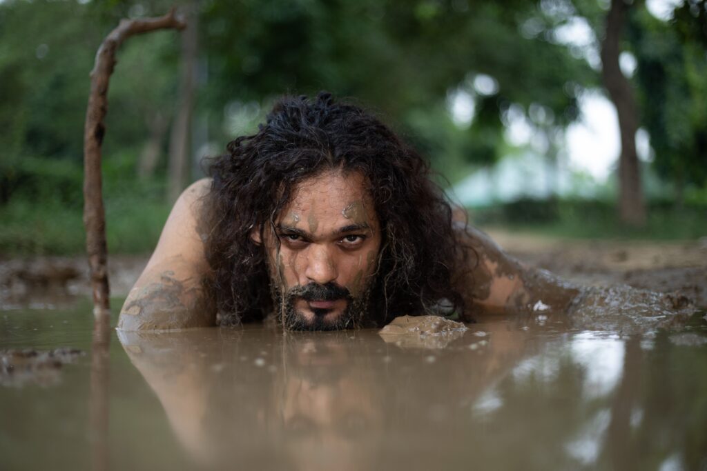 man-lying-down-in-mud