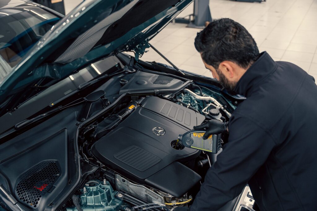 mechanic-checking-car-engine-oil-level-in-service-center