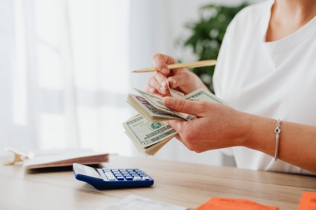 woman-counting-money-with-calculator