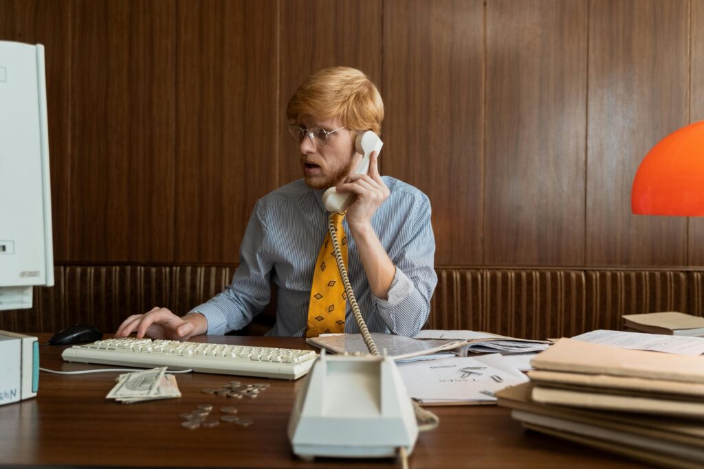man-in-blue-dress-shirt-talking-to-the-telephone