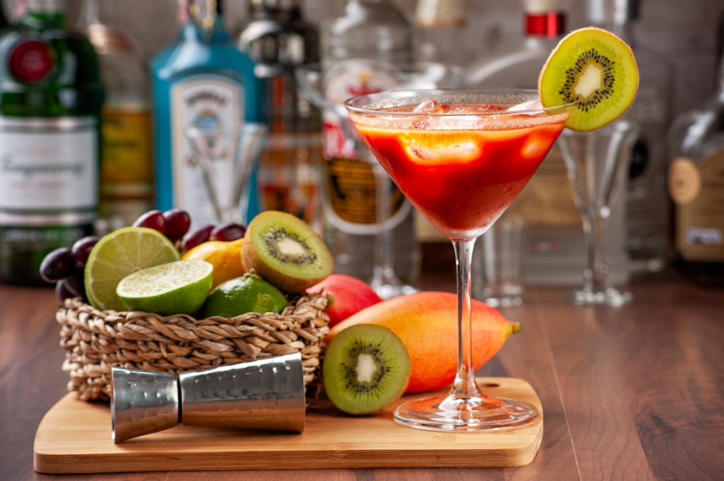 Vibrant cocktail with fresh fruit garnishes on a bar counter setting.