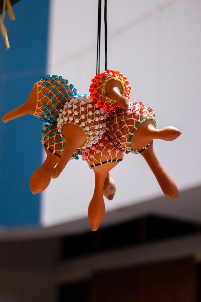 Vibrant set of hanging African rattles with colorful beads in natural light.