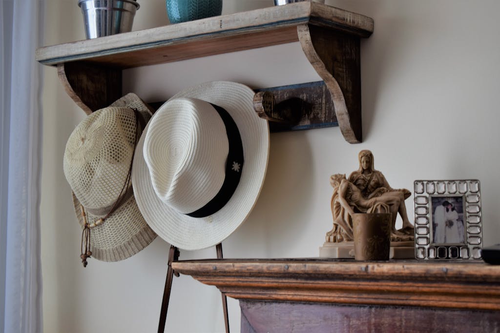 Vintage wooden shelf with summer hats and decorative items in Brazilian home.